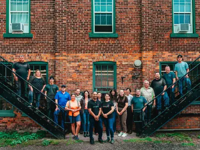 Group of people standing in front of a brick wall
